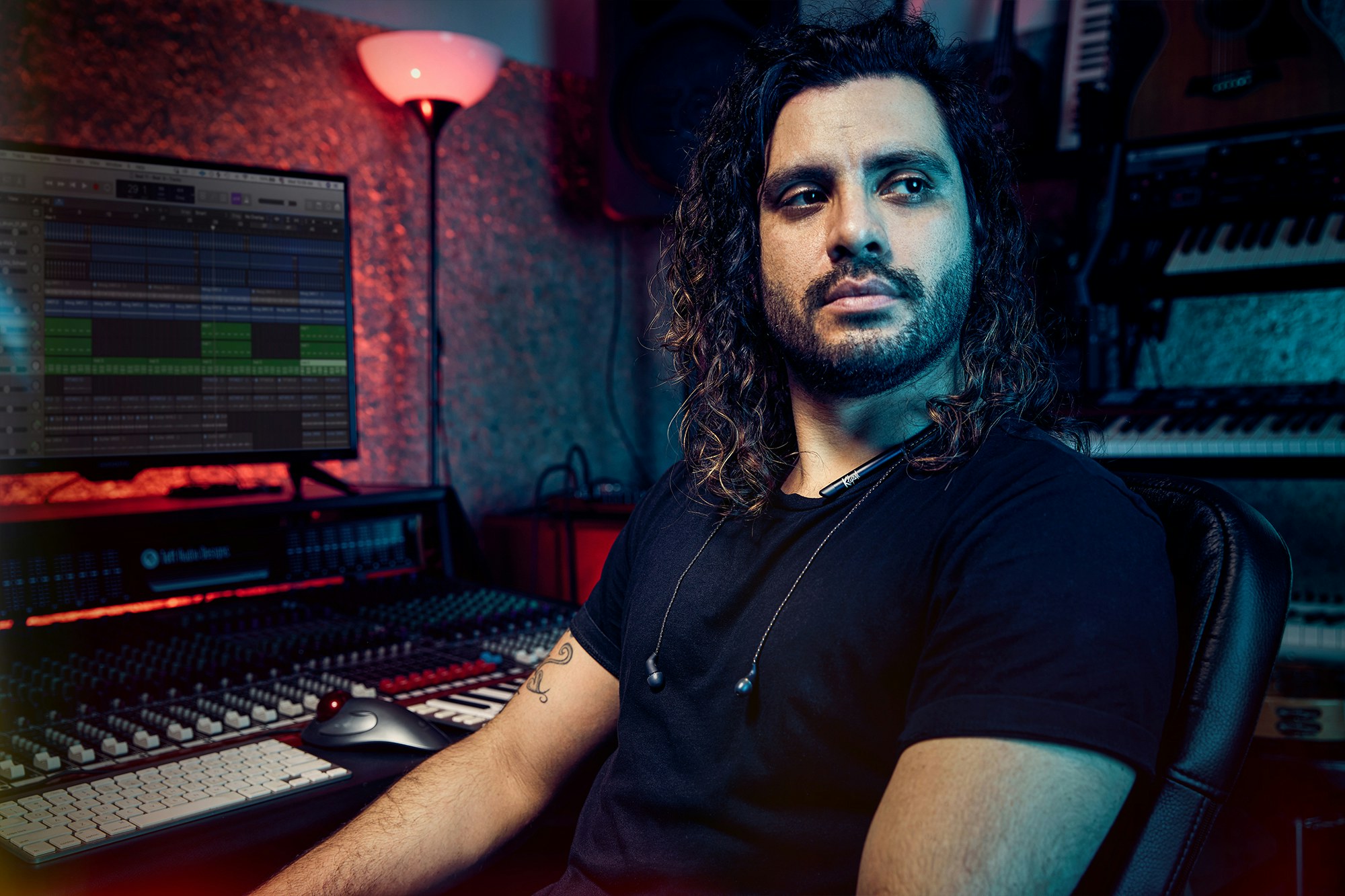 Man in recording studio listens to the T5 Neckband